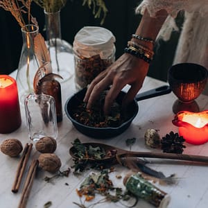 spring equinox rituals a table with a white tablecloth spoons bowls with herbs lit candles